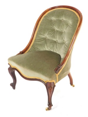 A Victorian rosewood spoon back nursing chair, upholstered in button back over stuffed green draylon, raised on cabriole legs.