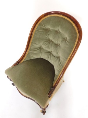 A Victorian rosewood spoon back nursing chair, upholstered in button back over stuffed green draylon, raised on cabriole legs. - 2