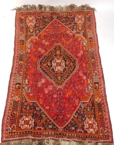 A Persian Shiraz type carpet, with a central medallion on a red ground decorated with flowers, leaves, birds, etc, within multiple borders, 160cm x 266cm.