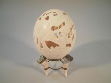 An ostrich egg pierced and carved with decoration of Ibix