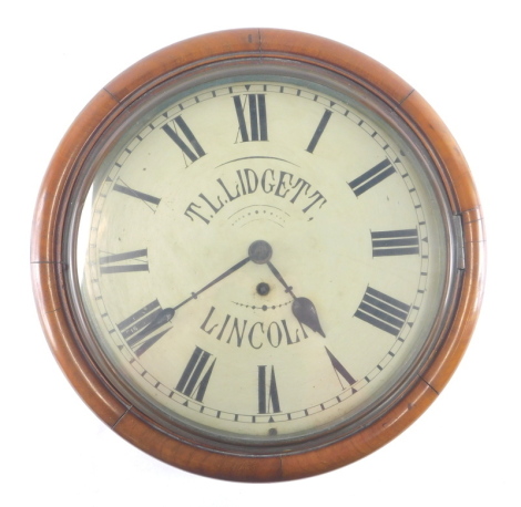 T. L. Lidgett, Lincoln. A 19thC mahogany wall clock, with 29cm diameter Roman numeric dial, in plain case, with single fusee movement, pendulum and key, 40cm diameter, complete with a black and white photograph of the shop front. Lidgett's were a watch a