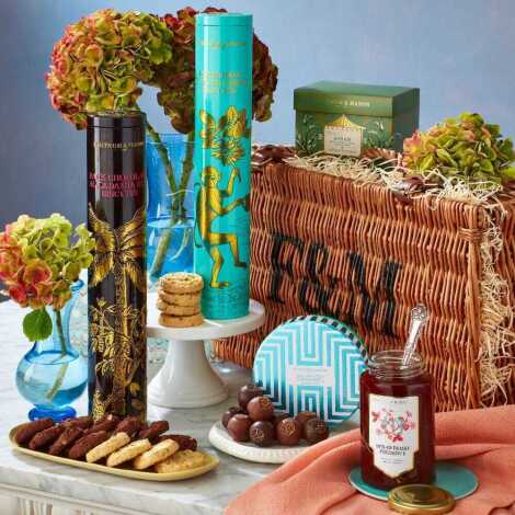 A Fortnum & Mason 'The Thank You' hamper, comprising chocolate and macadamia nut biscuits, strawberry preserve, pistachio and clotted cream biscuits, Fortnum's sea salted caramel truffle drum, and ASSAM 15 whole leaf silky teabags, enclosed in traditional