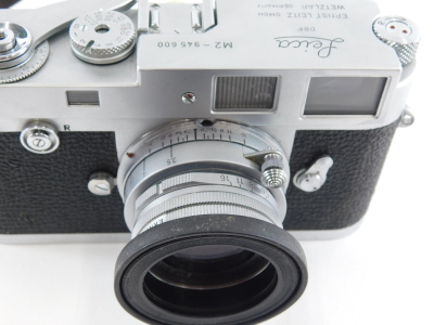 A Leica Leitz Wetzlar camera, M2-945 600, with Elmar f=5cm 1:2.8 lens 1634791, with outer case, 9cm high. - 3