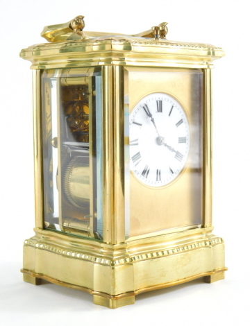 A late 19thC French brass repeating carriage clock, with swing handle and five part glazed case, 5cm diameter Roman numeric dial, striking and repeating on the hour, marked Paris, with key, 15cm high.