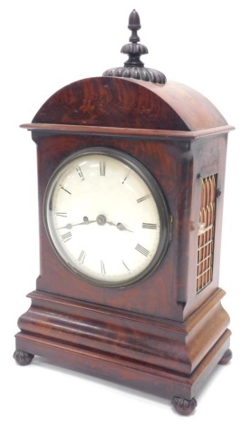 A Victorian mahogany bracket clock, the arched top with a turned and gadrooned finial above a painted dial, with 7 day movement and repeat, the figured case with a tapering plinth with lobed bun feet, 58cm high.