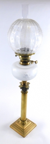 A late 19th/early 20thC oil lamp, with clear and opaque etched shade and a cut glass reservoir on a brass corinthian column base, 80cm high overall.