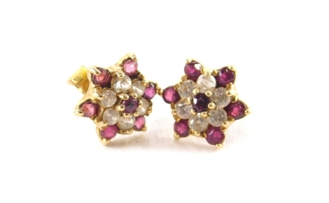 A pair of 9ct gold cluster earrings, each set with cz and garnets, on a layered design with single pin back and butterfly backs, 1cm wide, 1.8g all in.