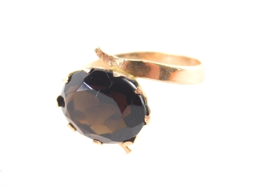 A smoky quartz dress ring, the oval faceted stone in a claw basket setting, on yellow metal band with faint markings, ring size Q½, 3.3g all in.