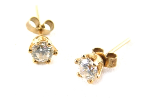 A pair of 9ct gold diamond stud earrings, each with round brilliant cut diamonds in a six claw basket setting, each approximately 0.15ct, on stick pin back with butterfly backs, 1.2g all in.