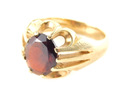 A 9ct gold gentleman's signet ring, set with single opal cut garnet, in claw setting, with pierced six point outer point border, and V splayed shoulders, ring size T½, 7g all in.