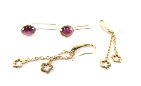 Two pairs of earrings, comprising a pair of 9ct gold drop earrings, each with two chain floral clusters, on arched back, 5cm high, and a pair of 9ct gold and amethyst cabochon set hoop earrings, 2cm drop, 4.5g all in.