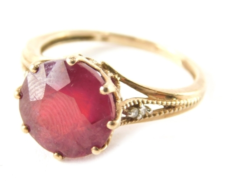 A 9ct gold garnet dress ring, the round brilliant faceted garnet, in a raised basket claw setting, with two tiny cz set shoulders, on reeded shoulders, ring size N½, 3g all in, boxed.