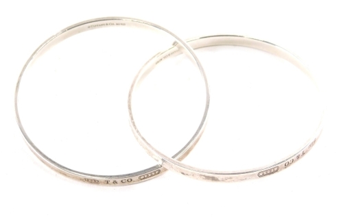 A pair of Tiffany bangles, each of plain form, marked Tiffany & Co AG925, 7cm diameter, 1.27oz. (2)