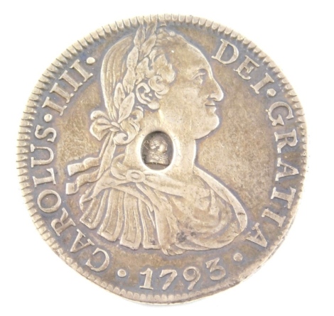 A Charles IV silver 8 Reales coin.