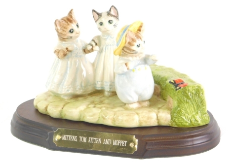 A Beswick Beatrix Potter figure group, Mittens, Tom Kitten, and Moppet, on wooden plinth base, printed marks beneath, 12cm high.