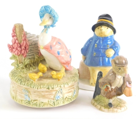 A Royal Albert Beatrix Potter figure Johnny Town-Mouse, a musical Jemima Puddle-Duck group, and a Coalport Paddington figure shopping, 1976 copyright mark. (3)