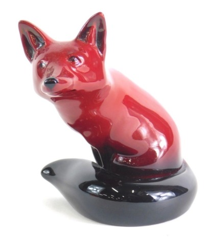 A Royal Doulton flambe figure of a seated fox, marked beneath, 12cm high.