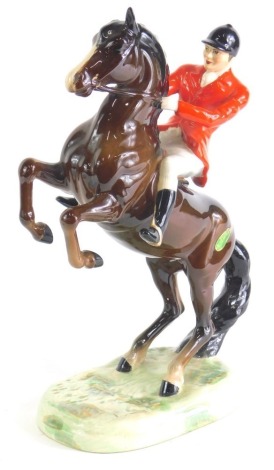 A Beswick red jacketed rearing huntsman, number 868, printed marks beneath, 26cm high. (AF)