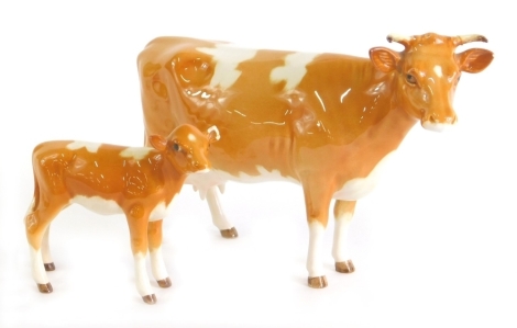 A Beswick Guernsey cow, 12cm high, and calf, printed marks beneath. (2, AF)