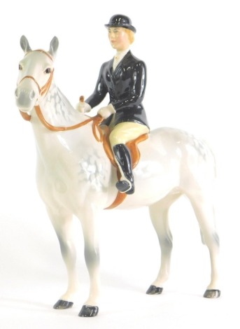 A Beswick black jacketed huntswoman, printed marks beneath, 23cm high.