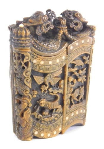 A highly elaborate Chinese horn box, with clip back, fixed carved doors, surmounted by dragons, probably 19thC, 7cm high.