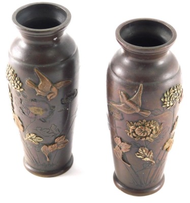 A pair of Japanese Meiji period bronze vases, each circular body raised with birds and flowers, on circular feet, unmarked, 16cm high.