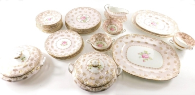 An early 20thC Spencer Stevenson dinner service, to include two lidded tureens, graduated meat plates, gravy boat, 9cm high on stand, soup bowls, side plates, decorated with roses on a pink ground with gilt highlights, printed marks beneath. (a quantity)