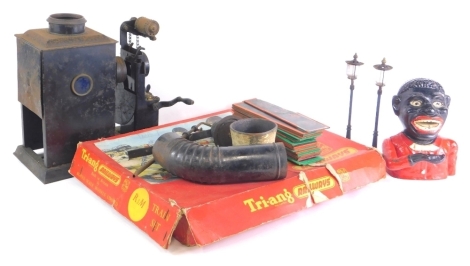 A collection of toys, to include a pair of early 20thC German miniature street lamps, a Tri-ang train set R3M, a money box and a magic lantern. (AF)