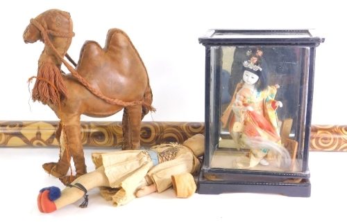 Miscellaneous items, to include a Greek costume doll, a leather camel, an oriental costume doll in glazed case and a didgeridoo.