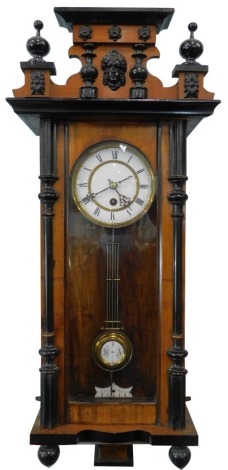 A 19thC Vienna wall clock, with 19cm diameter dial in a part ebonised case, 57cm high.