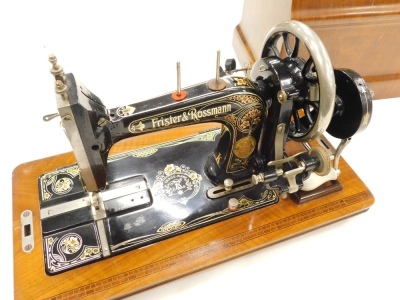 A Frister and Rossmann sewing machine, decorated in black and gilt in figured walnut carrying case, 52cm x 42cm wide. - 2