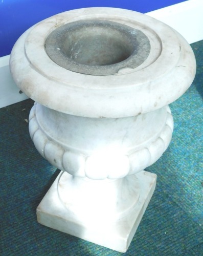 A baluster shaped marble floor urn, on a square plinth, 32cm high.