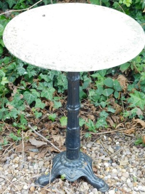 A cast iron garden table with circular white marble top, 49cm diameter.