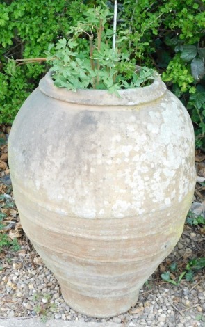 A stoneware bullet shaped olive jar, 90cm high.