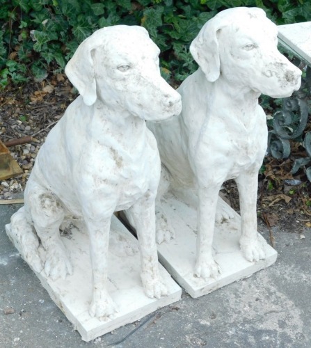 A pair of composition models of seated hounds, each on a rectangular base, 77cm high.