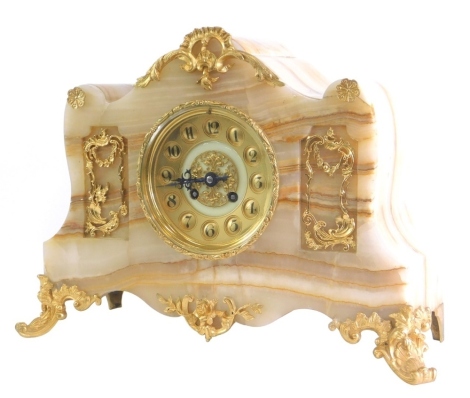 A late 19th/early 20thC French onyx and gilt metal mantel clock, the dial with Arabic numerals, on scroll feet, 38cm high, 40cm wide.