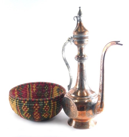 A Middle Eastern engraved copper coffee or water pot, with a elongated spout, decorated with scrolls, etc., with a shaped handle, 55cm high, and a Continental woven bowl. (2)