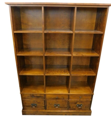 A Laura Ashley hardwood display unit, with various compartments, above six drawers, on a plinth, 183cm high, 127cm wide.