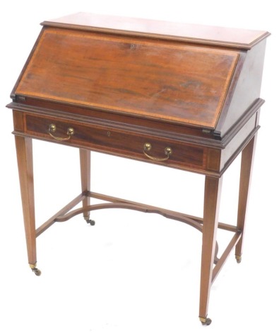 An Edwardian mahogany and satinwood cross banded bureau, the fall enclosing a fitted interior above a frieze drawer on square tapering legs with U shaped stretcher, 76cm wide, 132cm diameter.