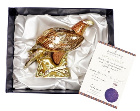 A Royal Crown Derby porcelain Golden Eagle paperweight, modelled by Donald Brindley and decorated by Tien Manh Tinh, limited edition no. 32/300, gold stopper, 23cm high, boxed with certificate.
