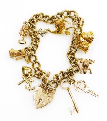 A 9ct gold curb link charm bracelet, with eight charms as fitted, on a heart shaped padlock clasp, with safety chain, 36.4g all in.