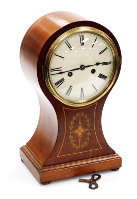 An Edwardian mahogany and boxwood inlaid balloon mantel clock, the cream enamel dial bearing Roman numerals, eight day movement, the case of conventional form, raised on four bun feet, 38.5cm high.