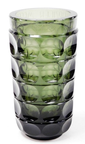 A mid 20thC Wilhelm Wagenfeld green glass vase, model number 84.01, designed for the Vereinigte Lausitzer Glaswerke (VLG) 1937, produced post WWII by the Oberlausitzer Glaswerke, Weisswasser (OLG), with five bands of repeating circular decoration, beneath