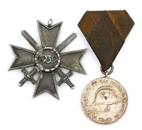 A German Third Reich Merit Cross, with crossed swords, and a Third Reich Hannover Fire Award. (2)