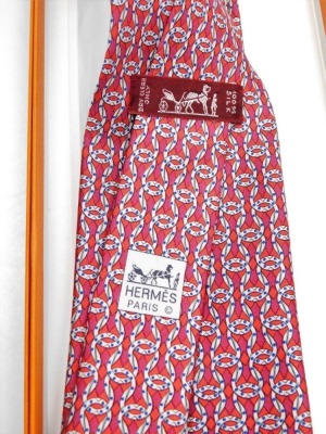 Two Hermes silk ties, comprising a red tie with linked design, and a blue tie with horse bit link design, both boxed. - 2