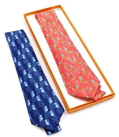 Two Hermes silk ties, comprising a red tie with all over beaver design, and a blue tie decorated with koalas, one boxed.