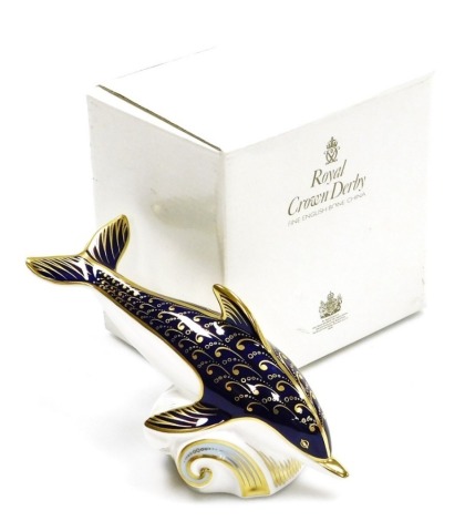 A Royal Crown Derby porcelain Dolphin paperweight, gold stopper and red printed marks, 17cm wide, boxed.