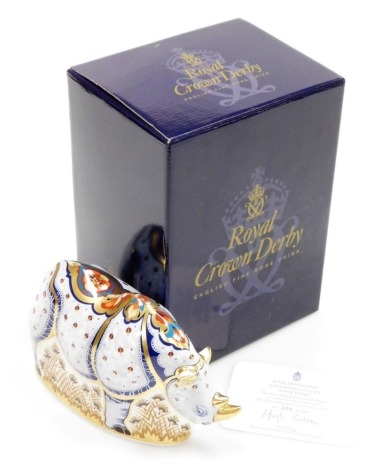 A Royal Crown Derby porcelain White Rhino paperweight, specially commissioned by Sinclairs, signed to base by C Sinclair and Louise Adams, limited edition no. 529/1000, gold stopper and red printed marks, 13cm high, boxed with certificate.