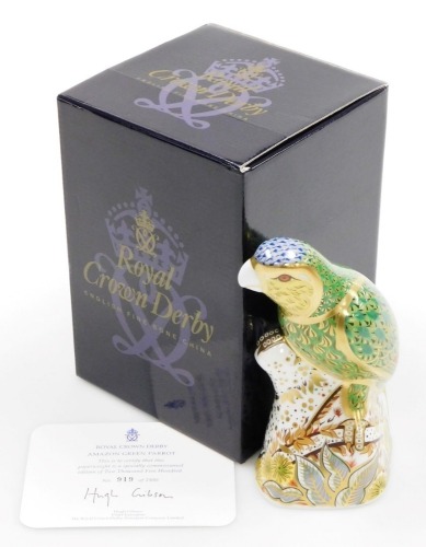 A Royal Crown Derby porcelain Amazon Green Parrot paperweight, limited edition no. 919/2500, gold stopper and red printed marks, 16cm high, boxed.