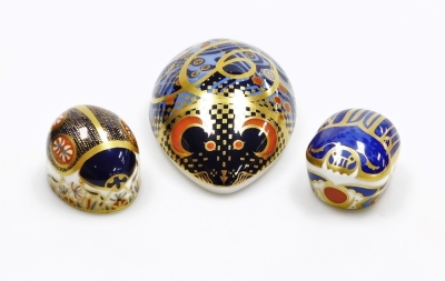 A group of Royal Crown Derby porcelain paperweights, comprising Computer Mouse, gold stopper and red printed marks, 12cm wide, Millennium Bug, gold stopper and red printed marks, 5.5cm diameter, and Blue Ladybird, silver stopper and red printed marks, 5.5 - 2